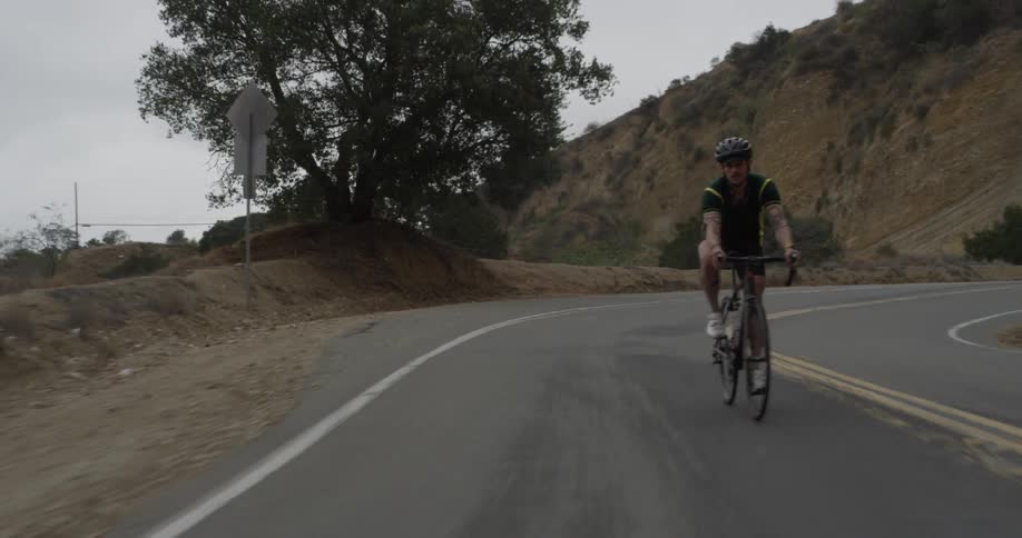 A man cycles down a large hill