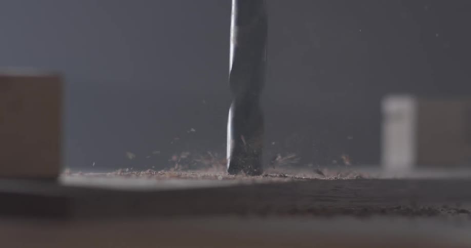 Close view of drilling through a piece of wood