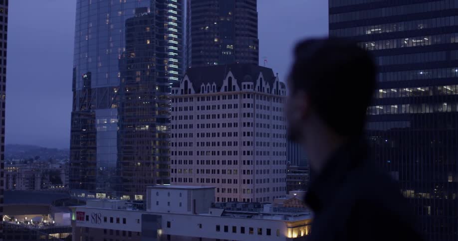 A man looking over a city at night