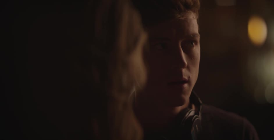 A man talks to a woman while looking away