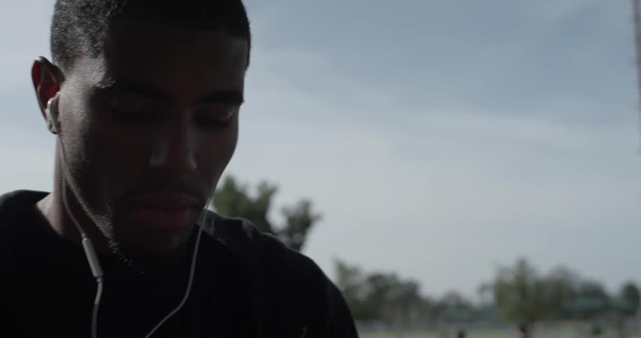 Man with wired earphones bobs to the music