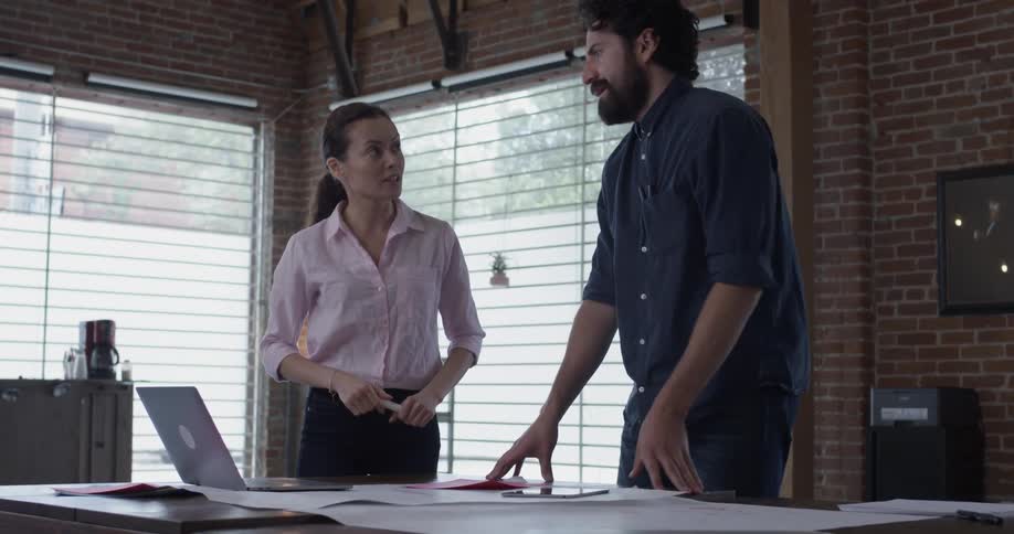 A man and woman are looking at a laptop inside