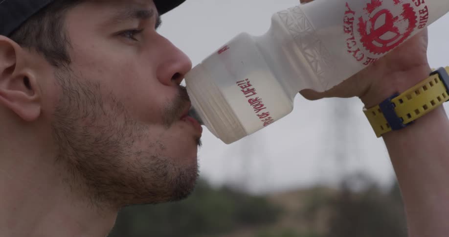 A man drinks out of a water bottle