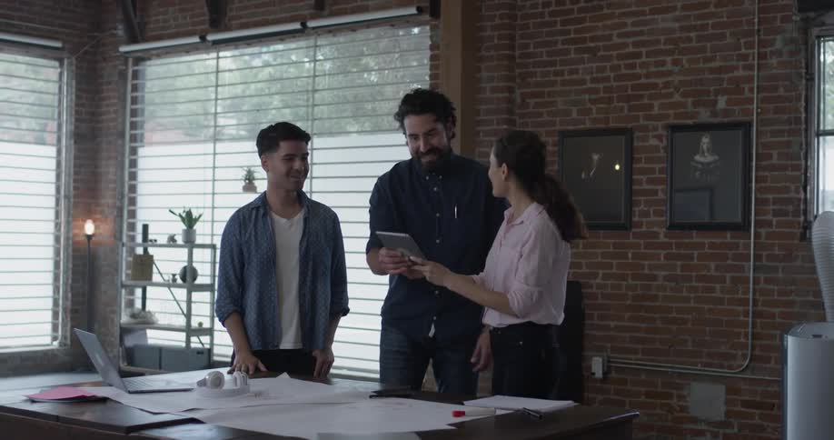 Co Workers Collaborating In Office