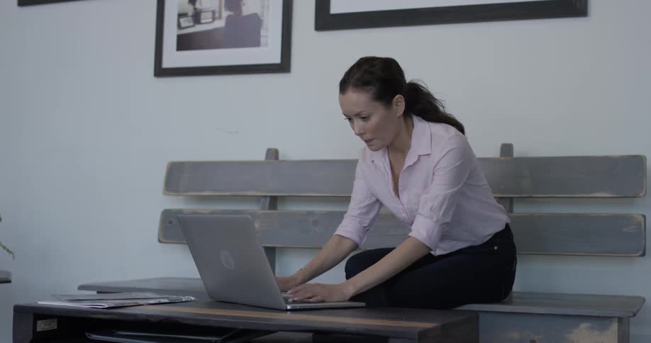 A woman typing on a laptop