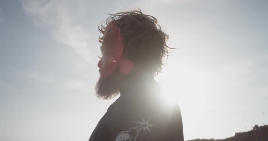 A man brushes his wetsuit