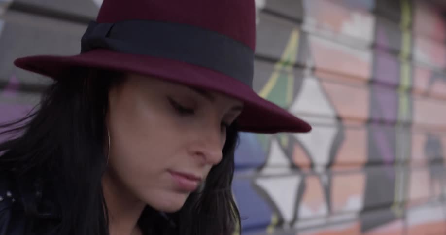 Woman with hat shaking her head dancing