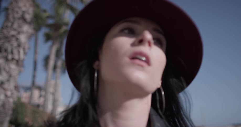 A woman has a concerned look walking down the street