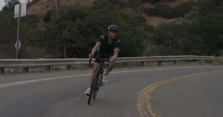Man rides bicycle down road