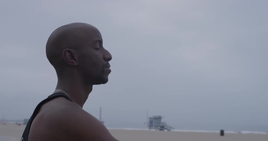 Man Meditating Outside By The Beach