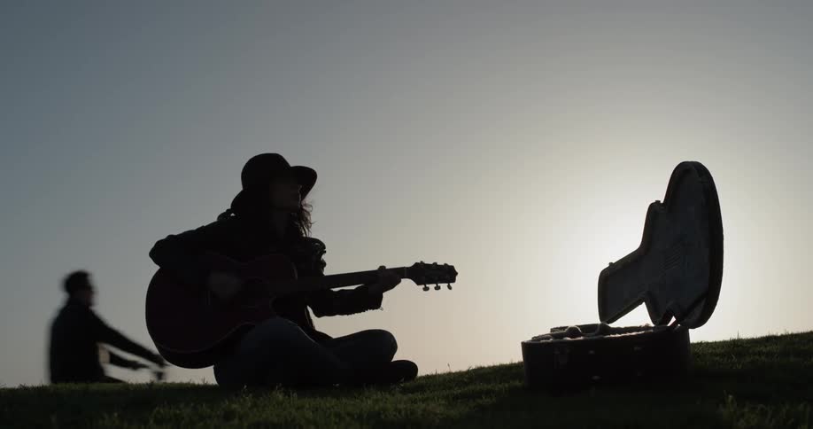 Girl Playing Guitar By The Beach