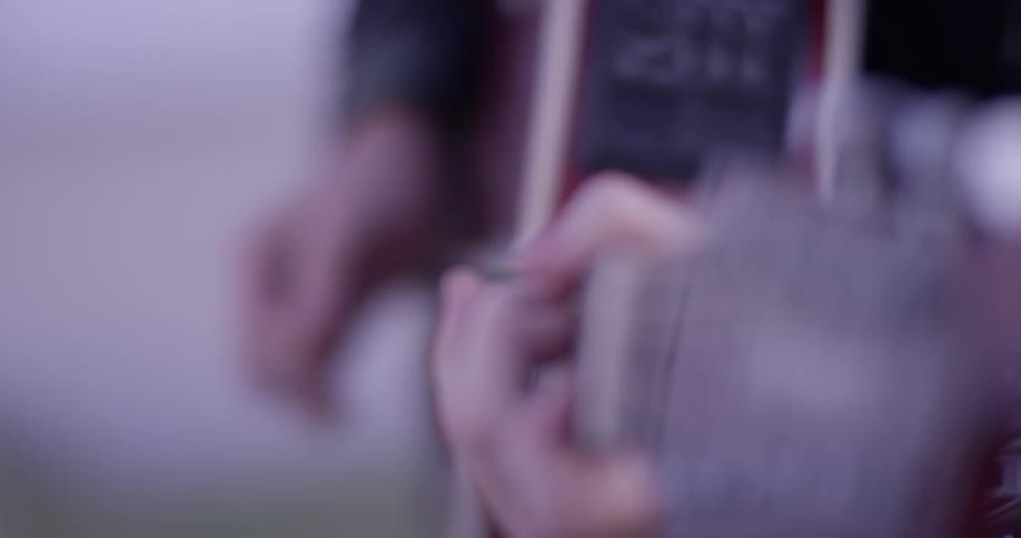 Person playing a red guitar