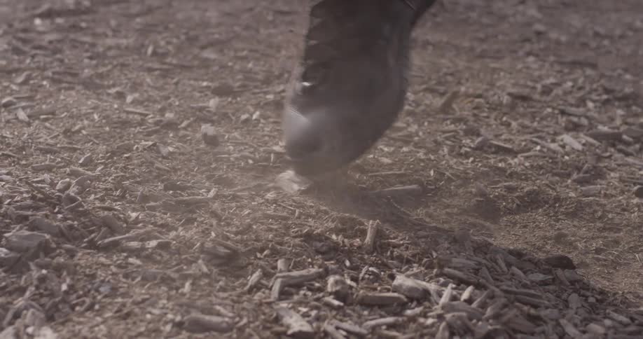 A pair of feet jumping around in mulch