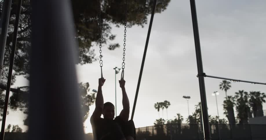A man grabbing some rings at a park