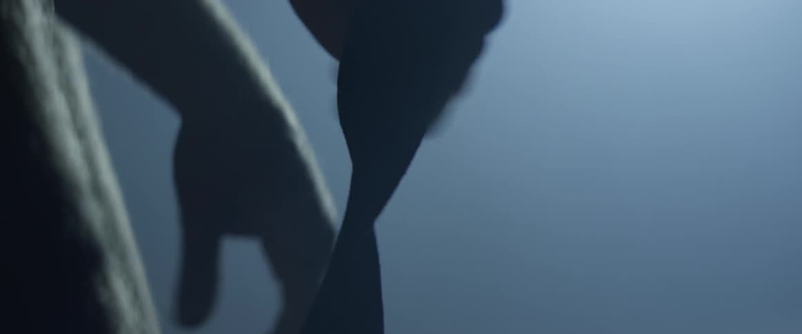 A person takes a cloth they had wrapped around their hand off
