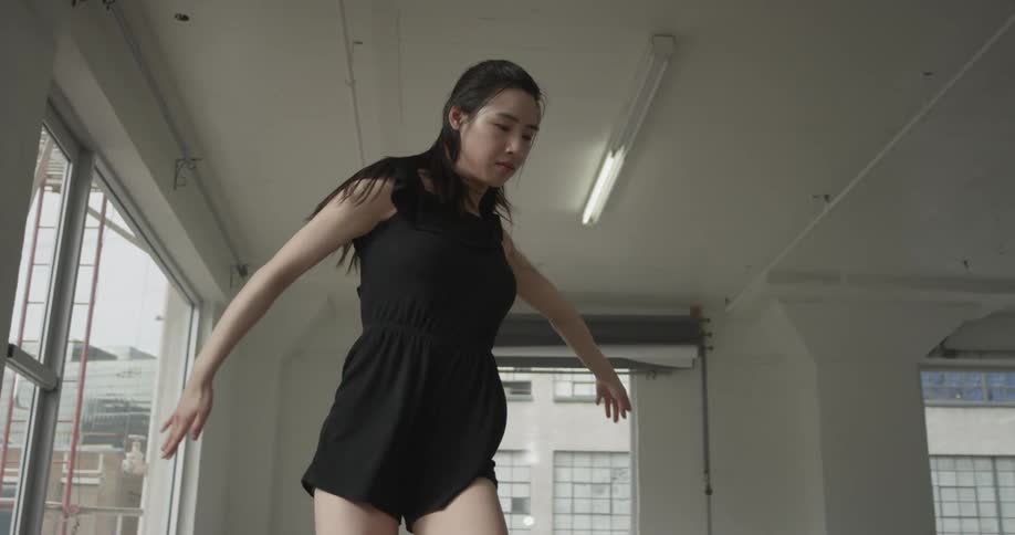 A woman dancing in a bright sunny studio