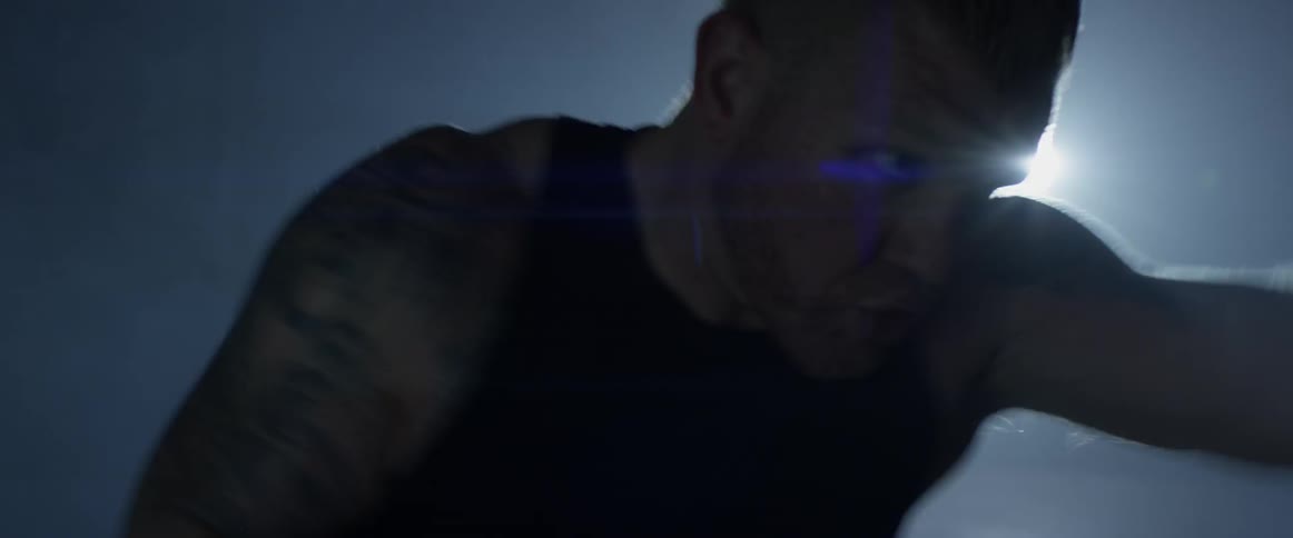 A man is hitting a punching bag