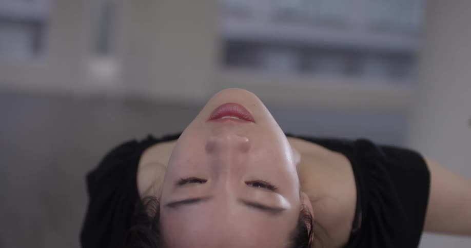 A dancer with her head leaning back straightens up and continues dancing
