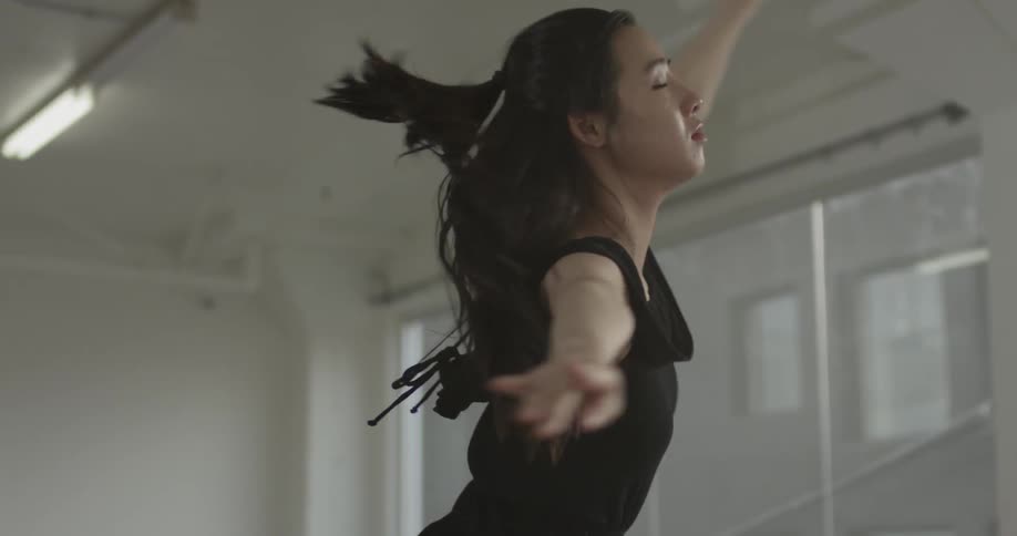 A woman dances in a black outfit