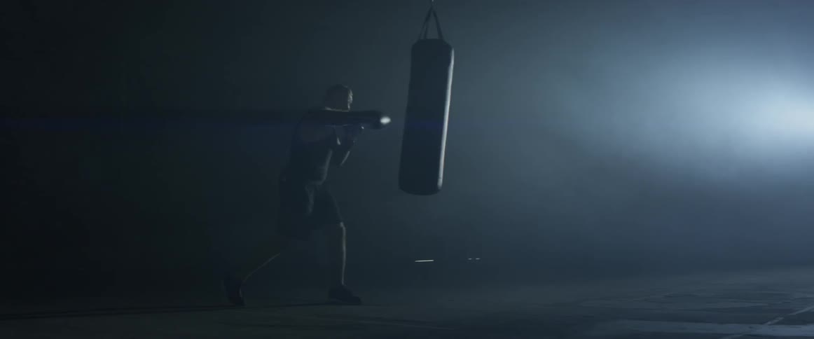 A man punching a bag in a gym