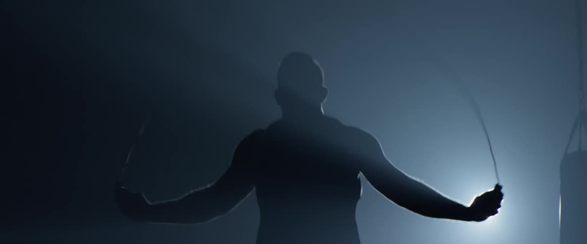 A man is jumping rope indoors