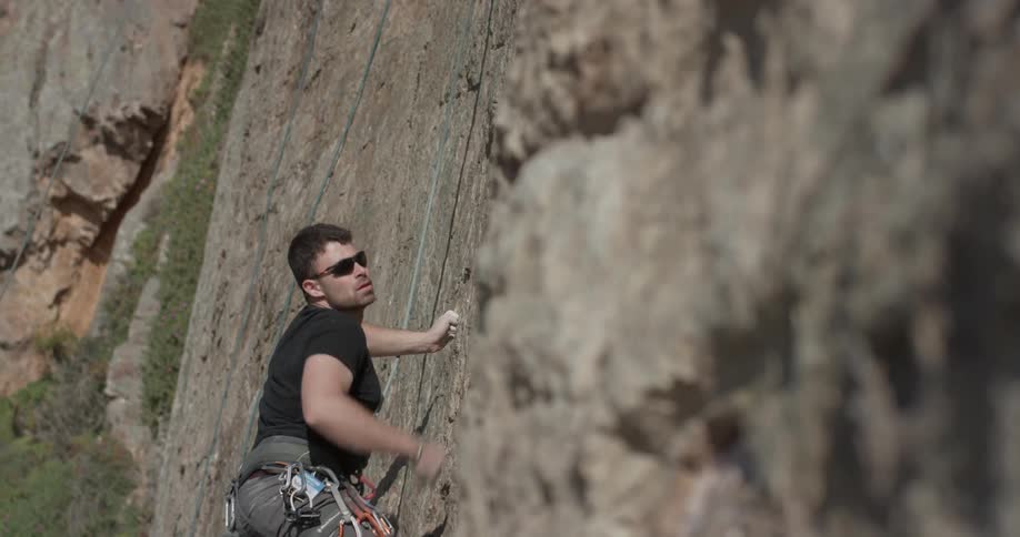 Man climbing a mountain in the afternoon
