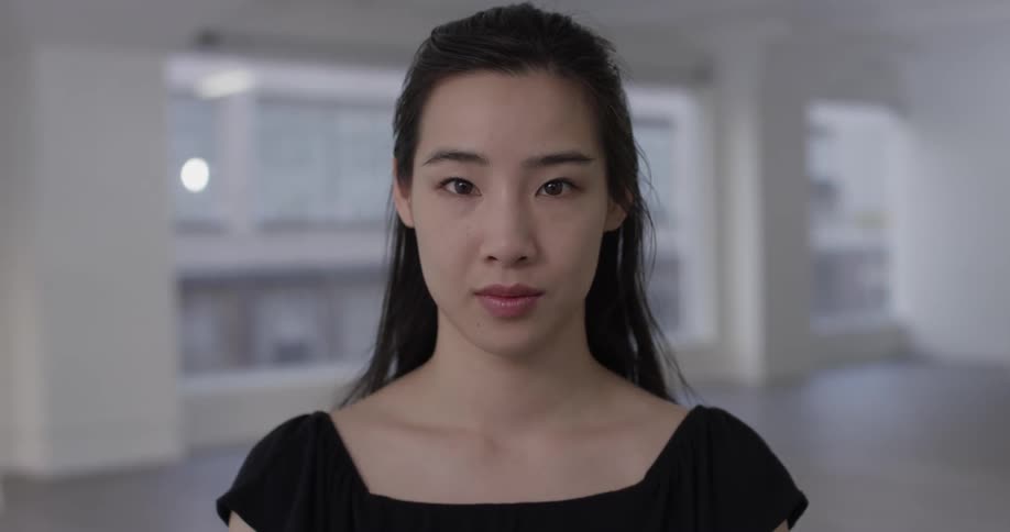Woman standing in vacant room then closes eyes