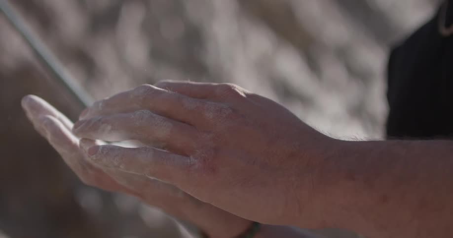A person with chalk covered hands