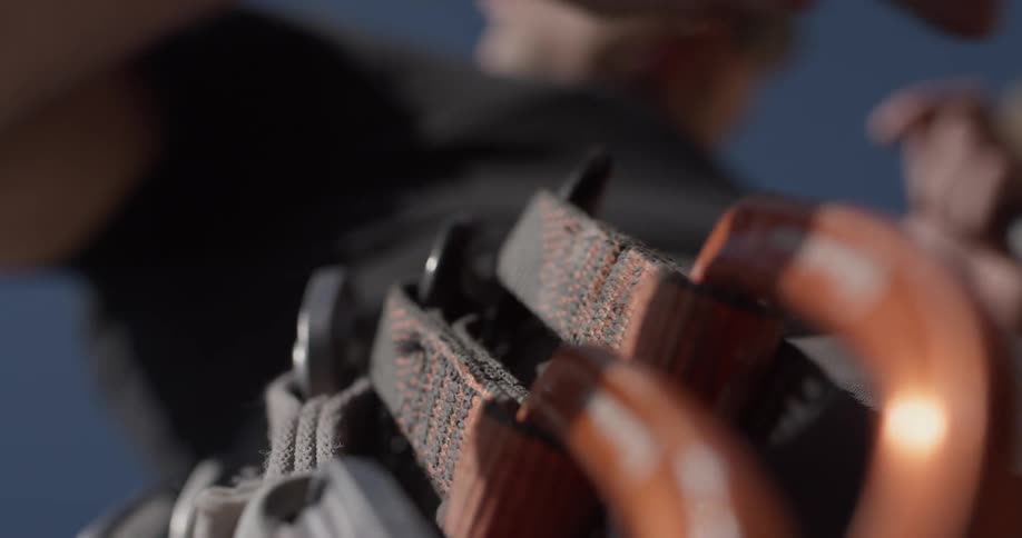 A man is clipping something to his belt