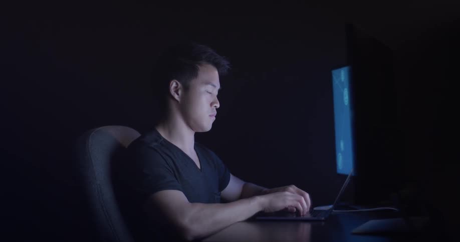 Man Coding On Computer In Dark Room