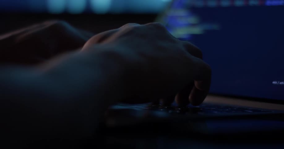 Man Coding On Computer In Dark Room