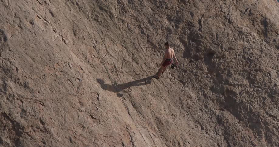 Man Climbing Wall By The Beach