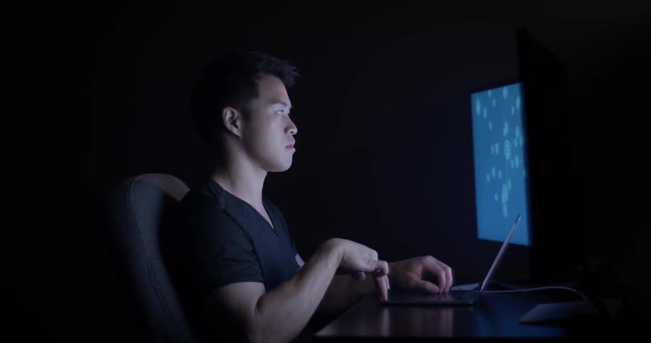 Man Coding On Computer In Dark Room
