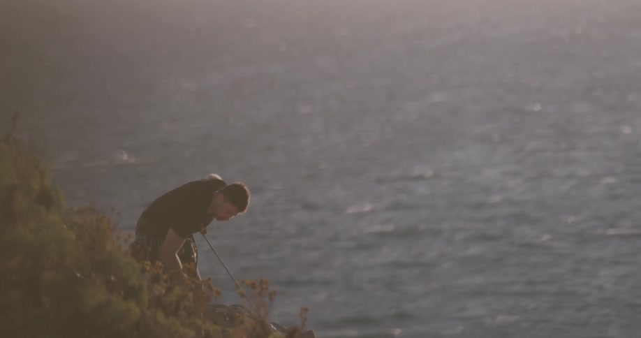 Man Climbing Wall By The Beach