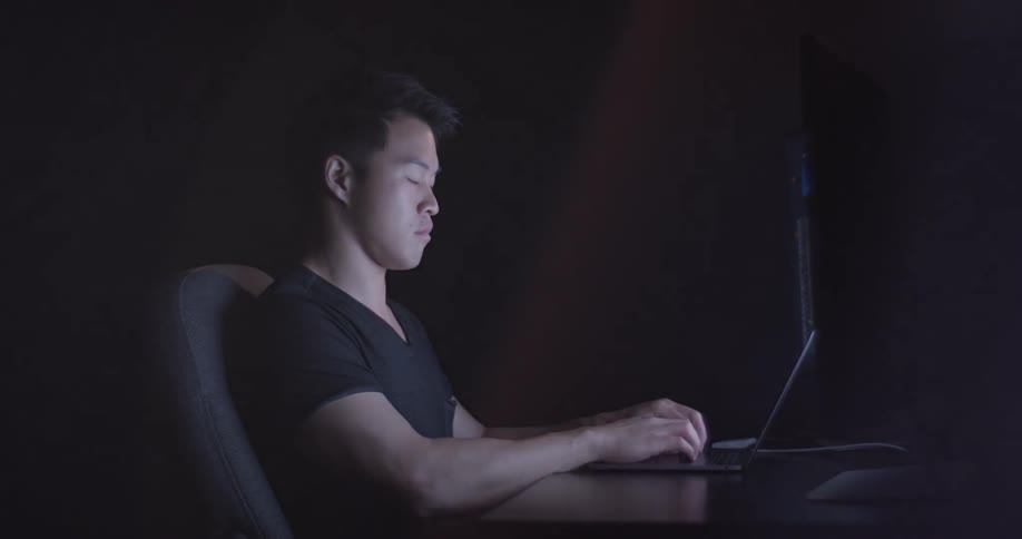 Man Coding On Computer In Dark Room