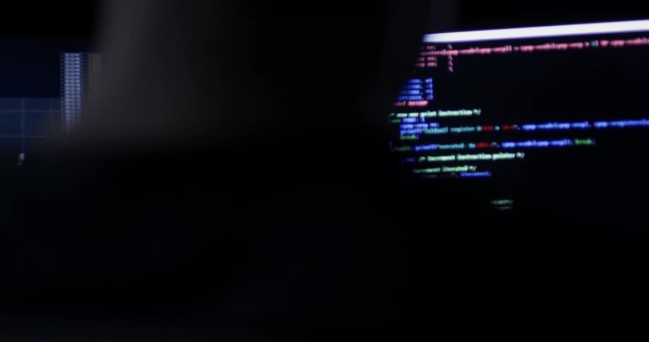 A person is working on multiple computer monitors at the same time