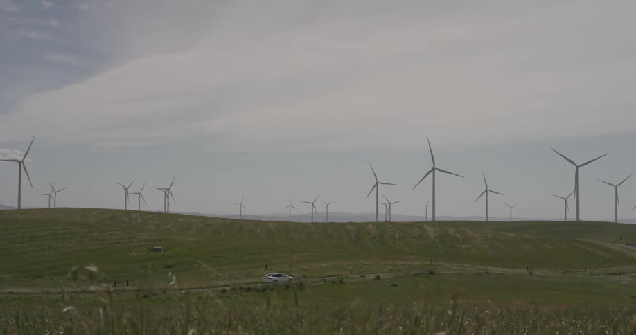 A lot of windmills rotating on some hills