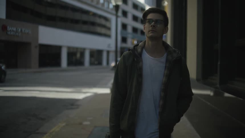 A man walking down a city sidewalk