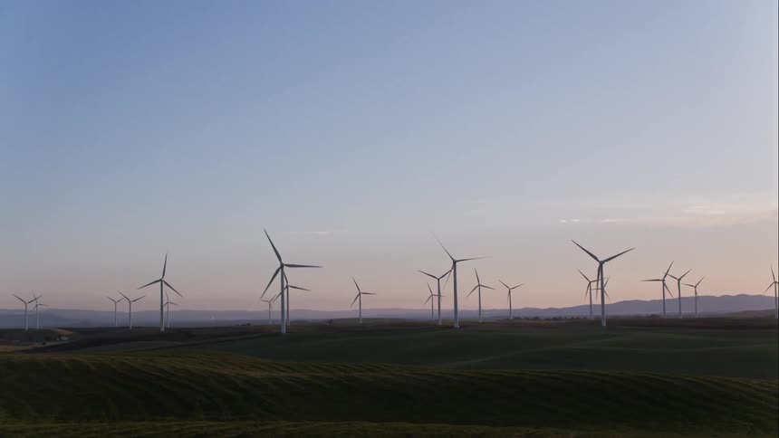 Windmills spinning in a field