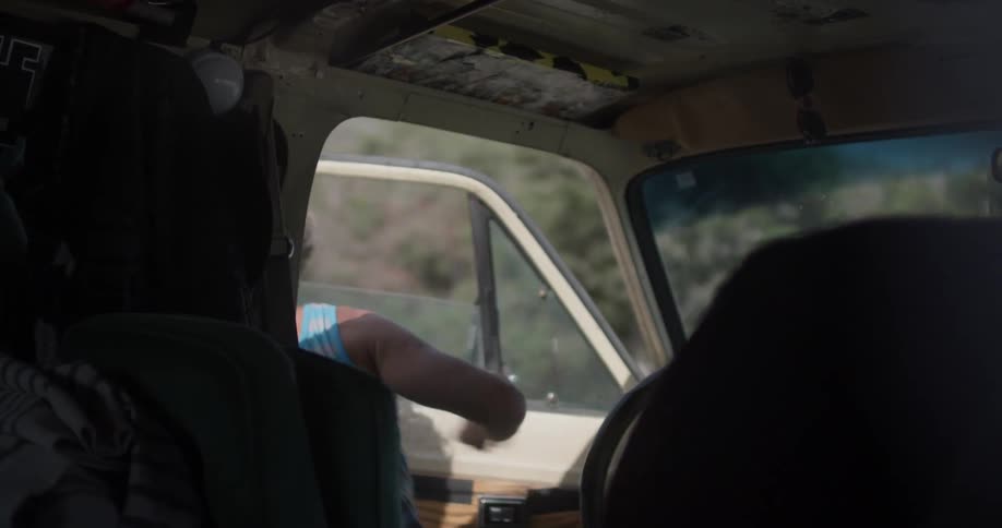 A man opens the car door and gets out of the car