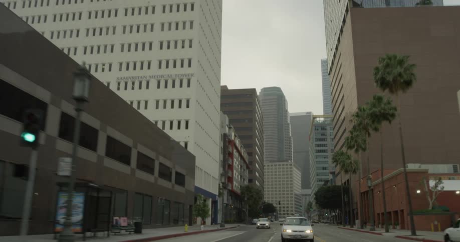 A car driving down a street in a large city