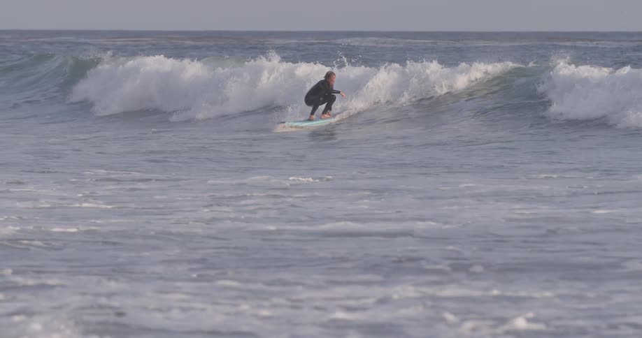 A man riding a surfboard on a large wave