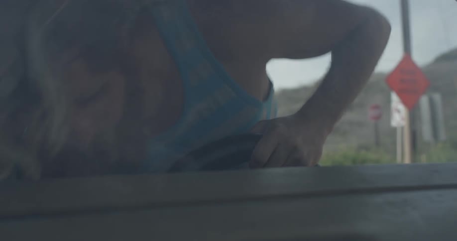 A man getting into the front of a van