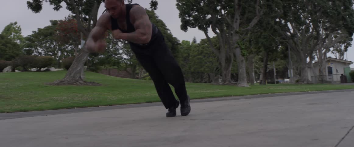 A muscular man does push up tricks on the concrete