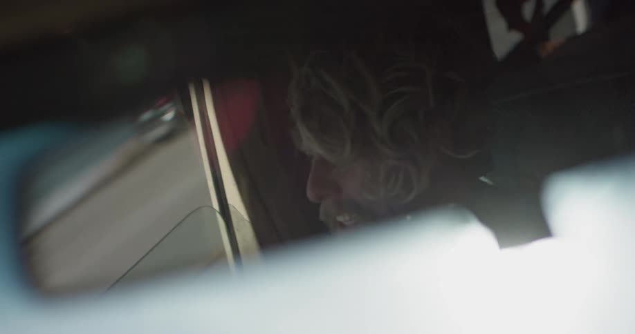 Man seen in rearview mirror