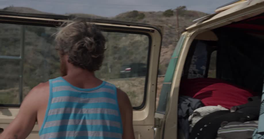 Man opening the back door on a van