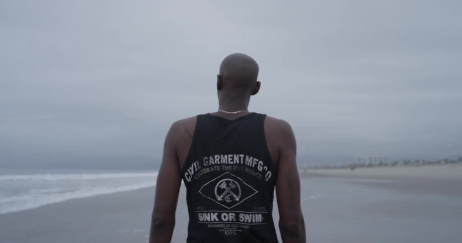 A man walking along the coast line