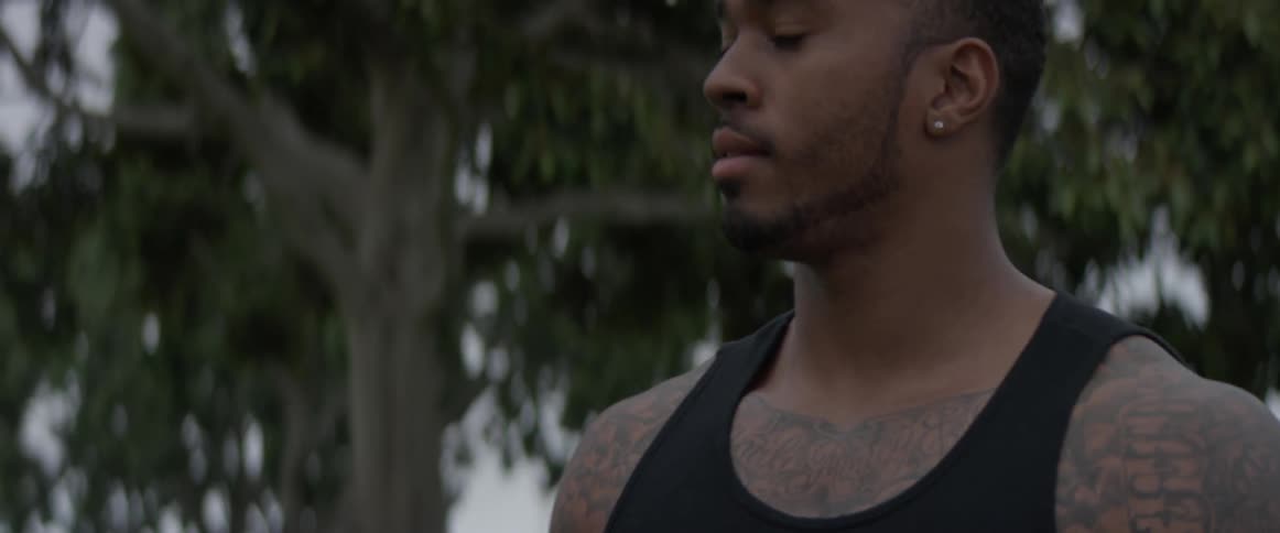 A man licks his lips while walking