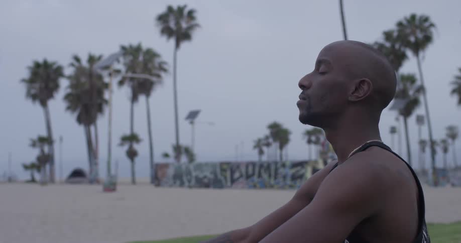 Man Meditating Outside By The Beach