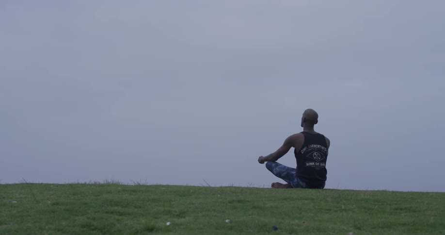 Man Meditating Outside By The Beach